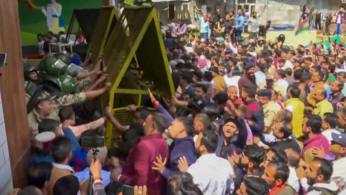 Protestors try to break security barricades during a protest over illegal construction in a mosque, at Sanjauli locality in Shimla.