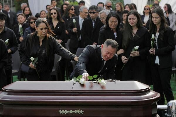 Kenji Fujimori mourns near the casket of Peru's former President Alberto Fujimori during his funeral service at a local cemetery in Lima, Peru 