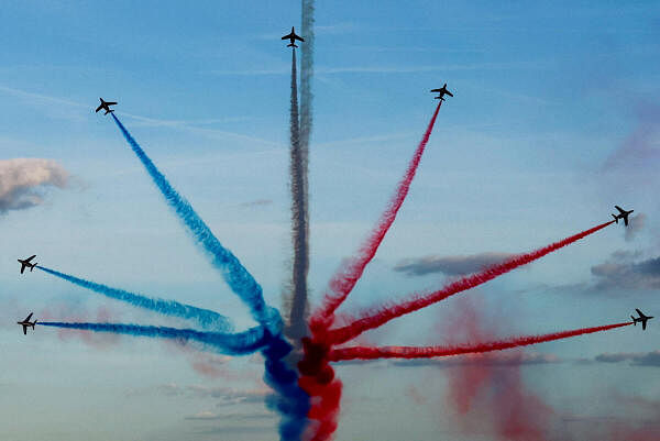 Aircrafts of the Patrouille de France fly over Paris during a parade at the Champs-Elysees avenue for all the French athletes who participated in the 2024 Olympics and Paralympics, in Paris, France 