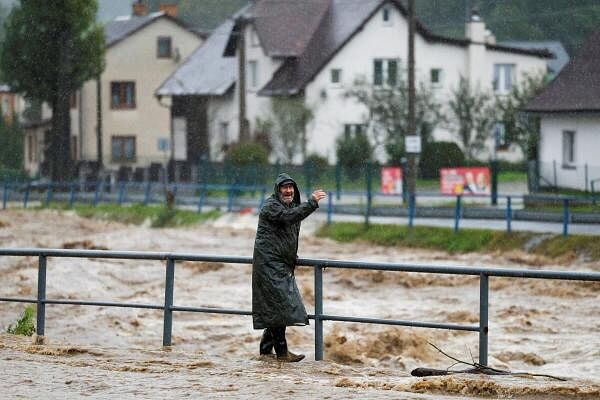 A person wades through a flood-affected road, following heavy rainfall in Jesenik, Czech Republic