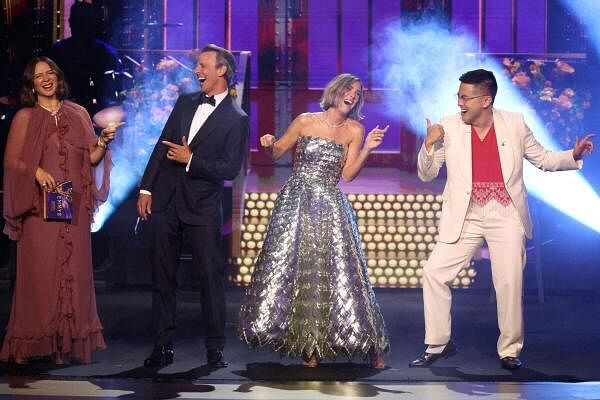 Presenters Seth Meyers, Maya Rudolph, Kristen Wiig and Bowen Yang laugh on stage at the 76th Primetime Emmy Awards in Los Angeles, California 