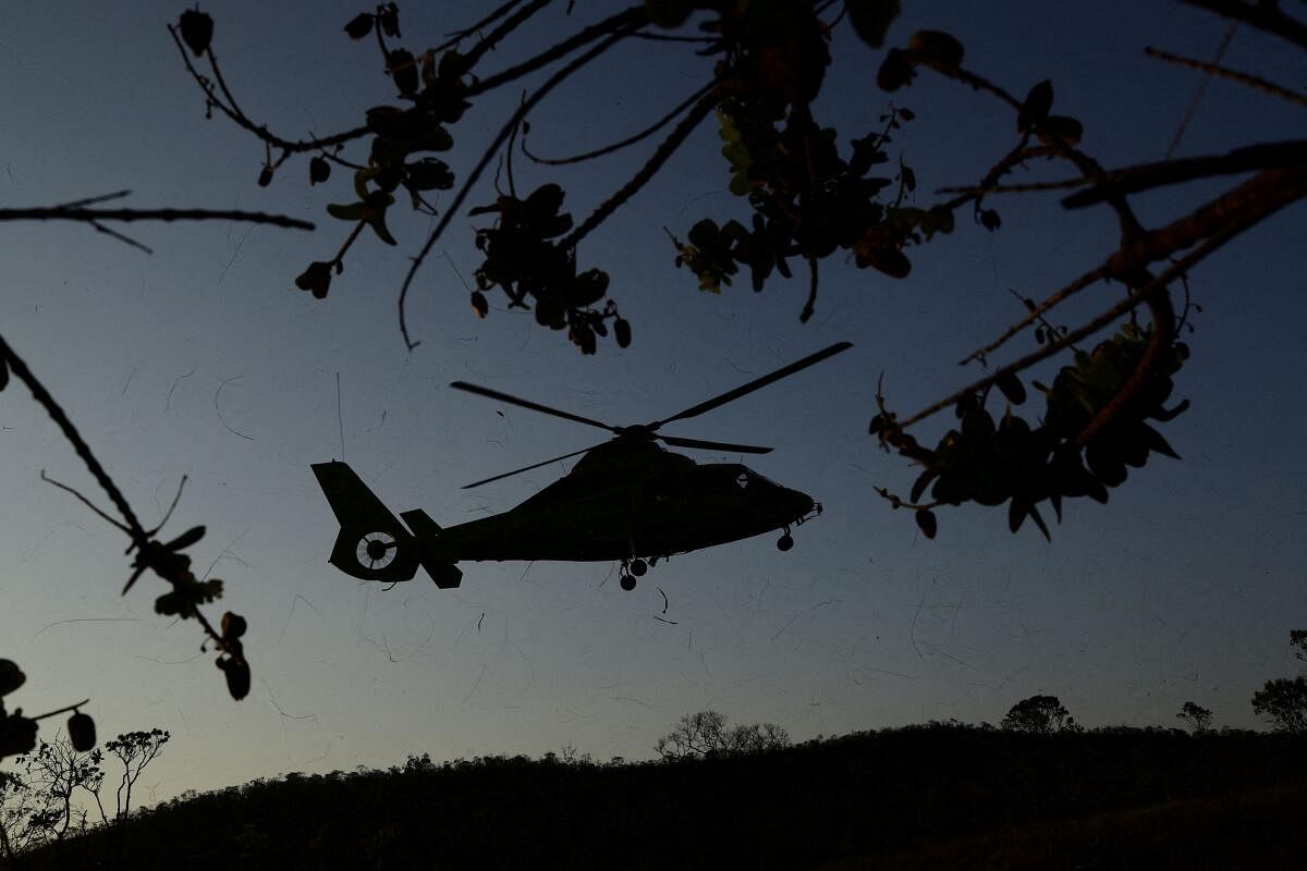 A helicopter arrives to collect agents of ICMBio (Chico Mendes Institute for Biodiversity Conservation) after their work to extinguish a fire in an area of Chapada dos Veadeiros National Park, in Alto Paraiso, Goias state, Brazil, September 19, 2024.