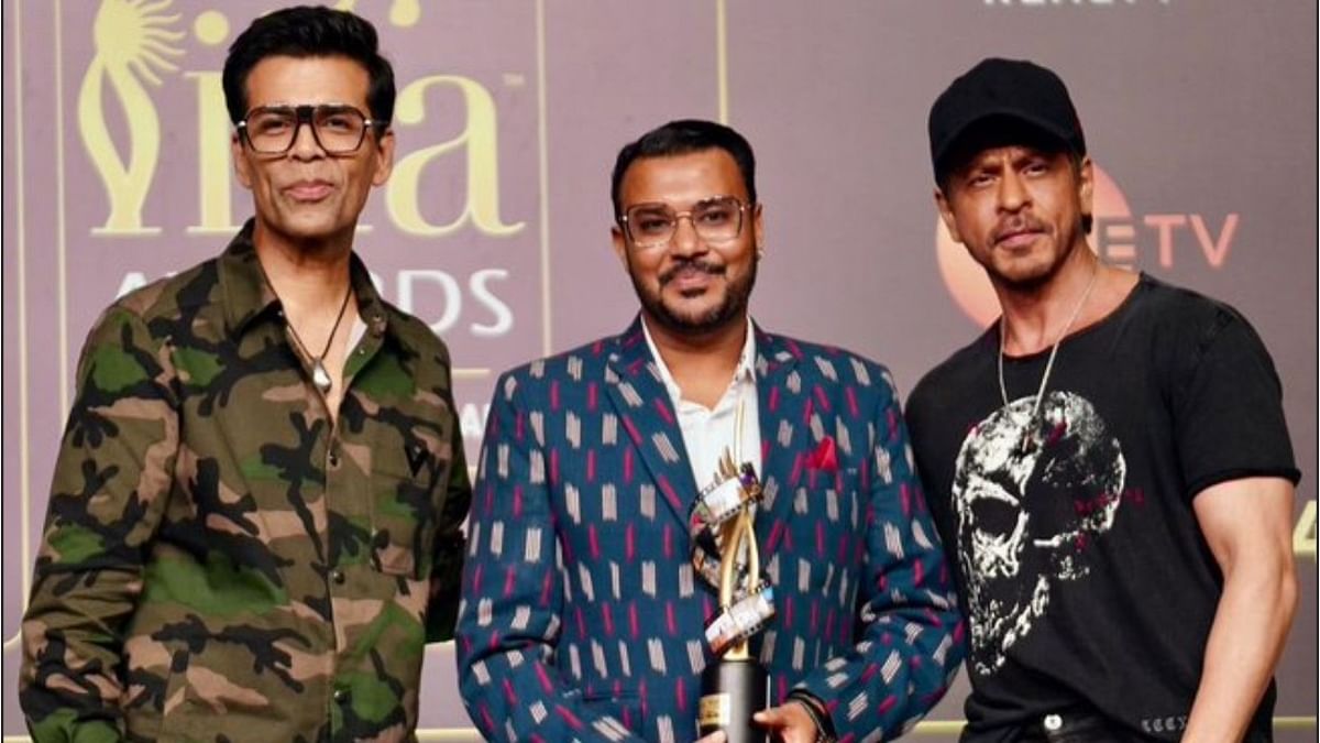 Puneet Gupta flanked by Karan Johar and Shah Rukh Khan.