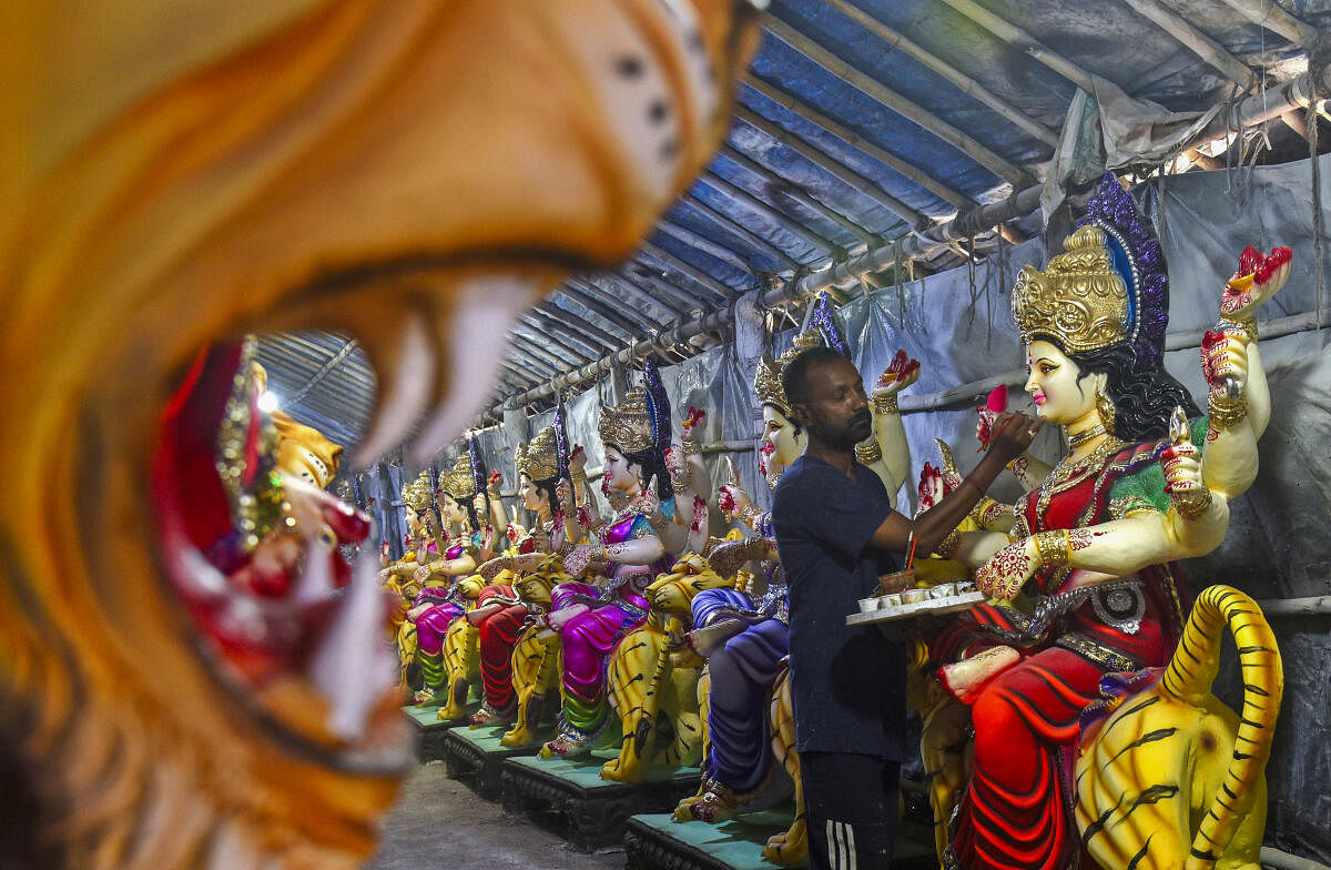 An artist gives finishing touches to an idol of Goddess Durga ahead of Navratri festival, in Hyderabad