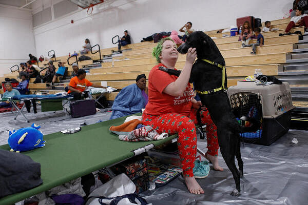 Amber Hardin, 27, spends time with her dog Ducky while taking shelter from Hurricane Helene at Leon High School near downtown Tallahassee, Florida, US.