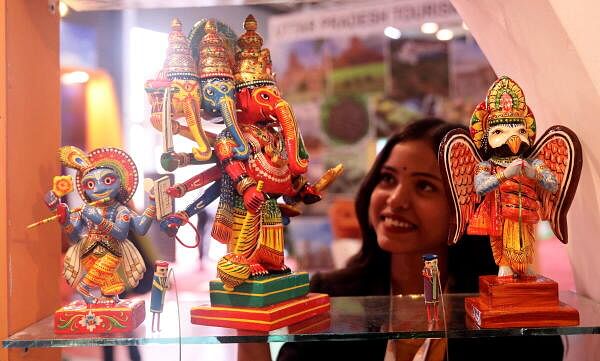 A visitor looks at the items displayed during the 2nd edition of Uttar Pradesh International Trade Show 2024, in Greater Noida, UP.