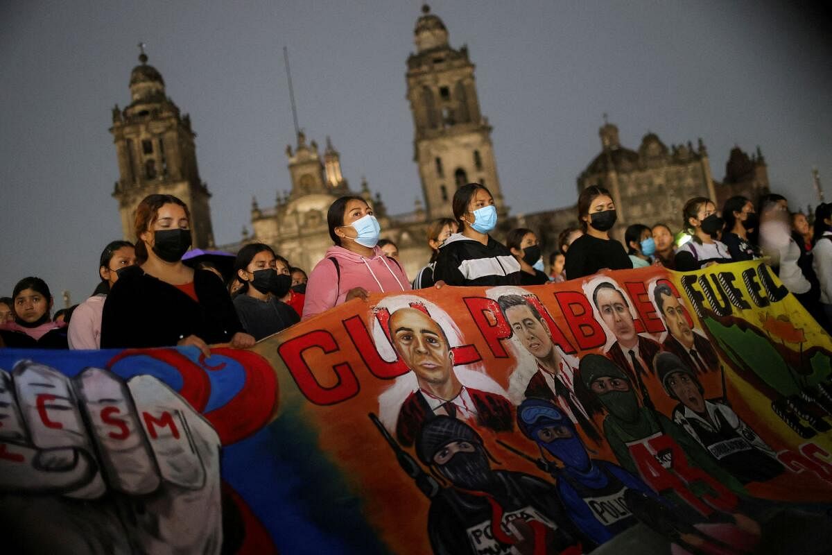 Demonstrators hold a banner as they take part in a march to demand justice in the 2014 disappearance of 43 student teachers from the Ayotzinapa Rural Teachers' College in Mexico City, Mexico.