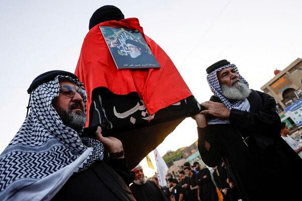 People carry a mock coffin of Lebanon's Hezbollah Chief Hassan Nasrallah who was killed by an Israeli airstrike in Beirut, during a symbolic funeral in Baghdad, Iraq.