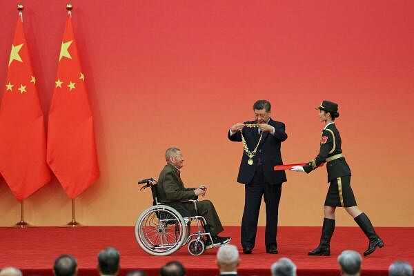 Chinese President Xi Jinping presents the Medal of the Republic to war veteran Huang Zongde at a presentation ceremony of national medals and honorary titles, at the Great Hall of the People ahead of the 75th founding anniversary of the People's Republic of China, in Beijing, China.