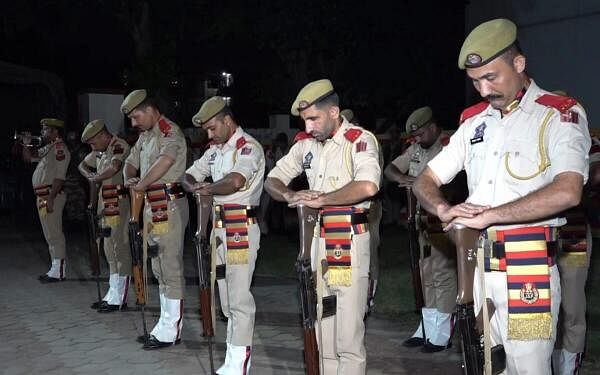 Police personnel during the wreath laying ceremony of head constable Bashir Ahmad, who lost his life in an encounter in Kathua district, at Gulshan Ground in Jammu.