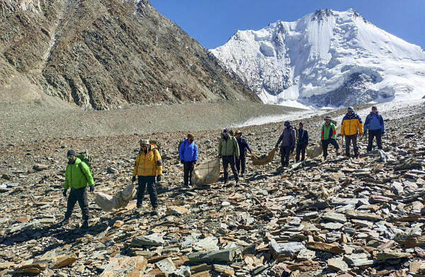 Personnel from the joint team of Indian Army's Dogra Scouts and representatives of Tiranga Mountain Rescue during a search and rescue mission to recover the remains of personnel from the Indian Air Force (IAF) AN-12 aircraft, which crashed on Rohtang Pass in 1968, Tuesday, Oct 1, 2024. The mission is part of the larger Chandra Bhaga Mountain Expedition and has recovered the remains of four more individuals from the site.