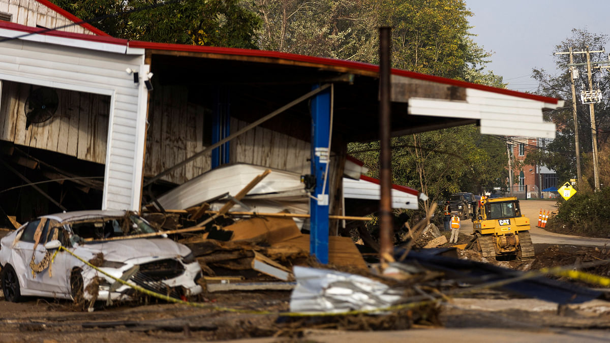 File Photo: Workers try to remove debris from destruction following the passing of Hurricane Helene, in Swannanoa, North Carolina, U.S., October 3, 2024. 