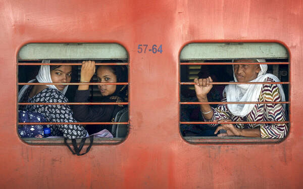 Passengers wait for their train to depart from a railway station after train services were affected due to 'Rail Roko' protest by farmers in Punjab, in Amritsar.