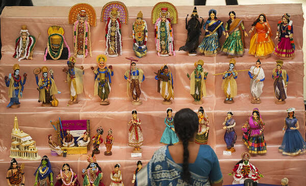 A visitor looks at dolls depicting scenes from Ramayana during the Dussehra Doll festival, on the first day of Navratri, at a mall in Bengaluru.