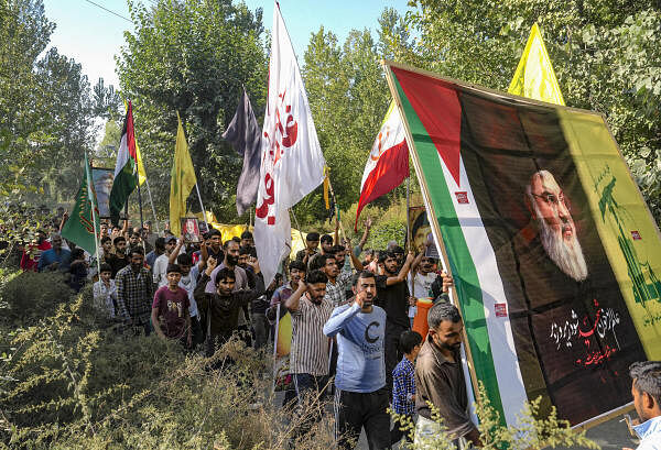 Shia Muslims take part in a protest march against Israel after killing of Hezbollah leader Hassan Nasrallah, on the outskirts of Srinagar.