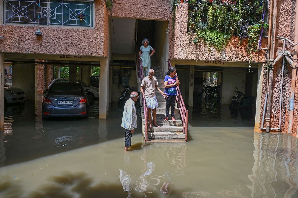 Residents of the Kendriya Vihar apartment complex in Yelahanka near Kogilu Cross look at the damage done due to Saturday