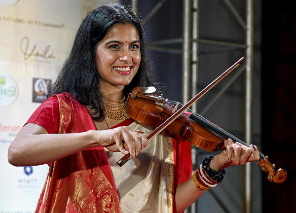 Paris Olympics double medallist Manu Bhaker plays violin during her felicitation ceremony, in Kolkata.