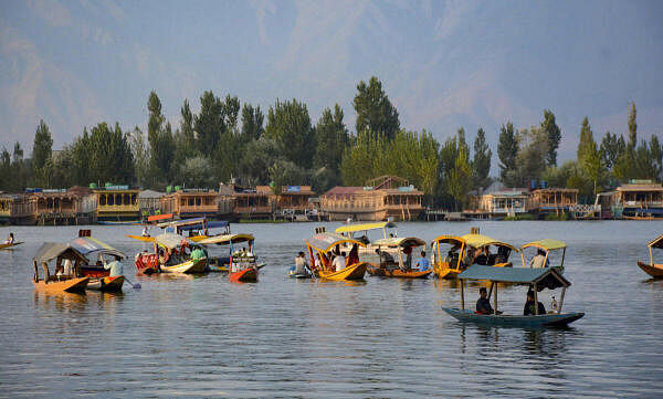 Tourists take 'shikara' ride, at Dal Lake in Srinagar.