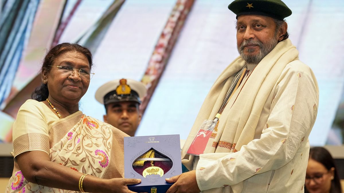 President Droupadi Murmu presents the Dadasaheb Phalke Award to veteran actor Mithun Chakraborty during the 70th National Film Awards, at Vigyan Bhawan, in New Delhi.