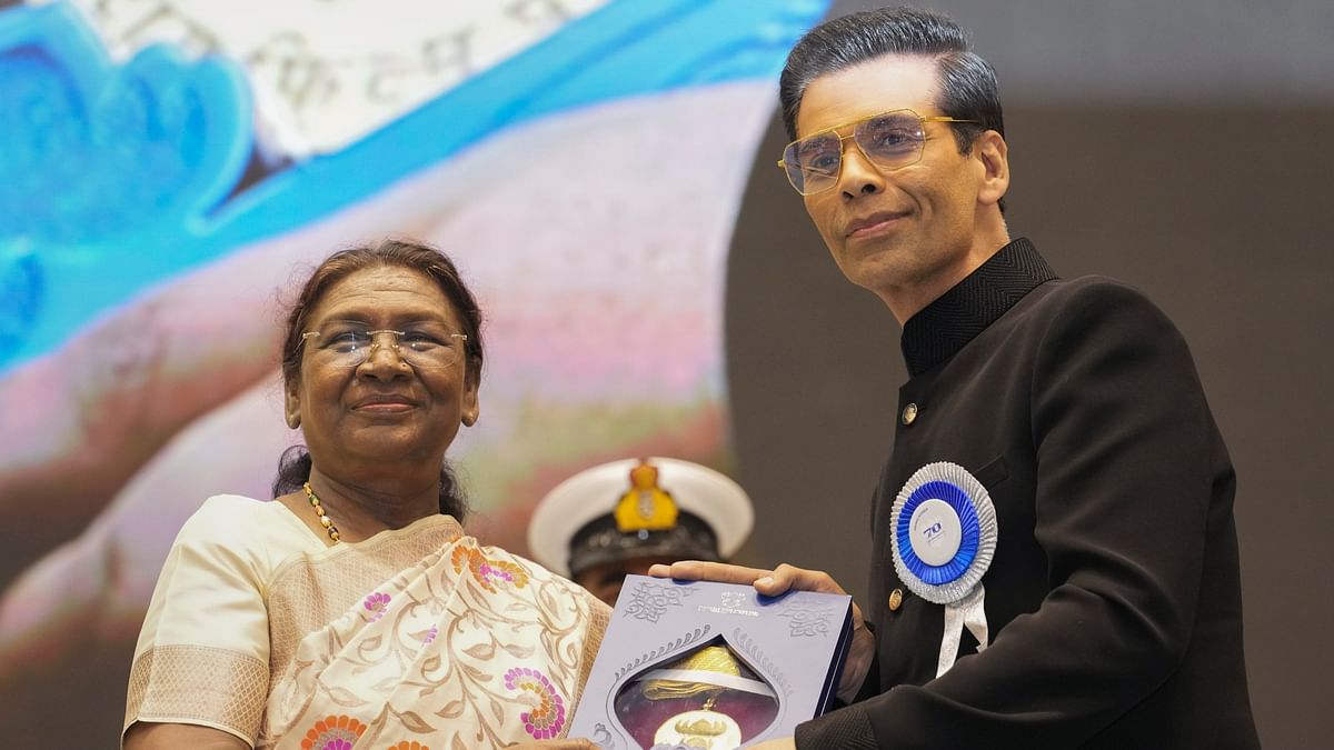 President Droupadi Murmu presents an award to Karan Johar during the 70th National Film Awards, at Vigyan Bhawan, in New Delhi.