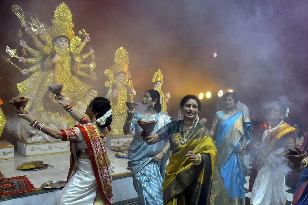 Women perform 'Dhunchi' dance during Durga Puja festival, at Durgabadi in Jaipur.