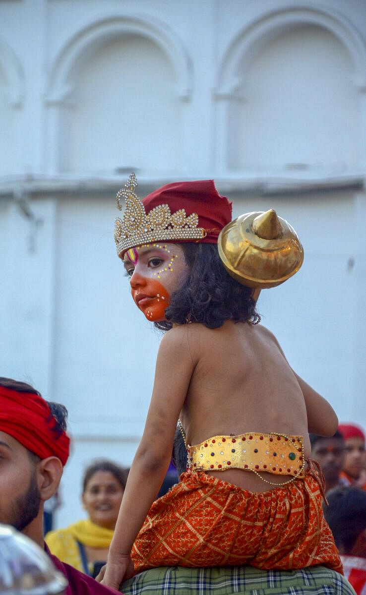 A child dressed as a 'langoor' takes part in a religious procession, marking the Navratri festival and 'Langoor Mela' celebrations, at Durgiana temple in Amritsar.