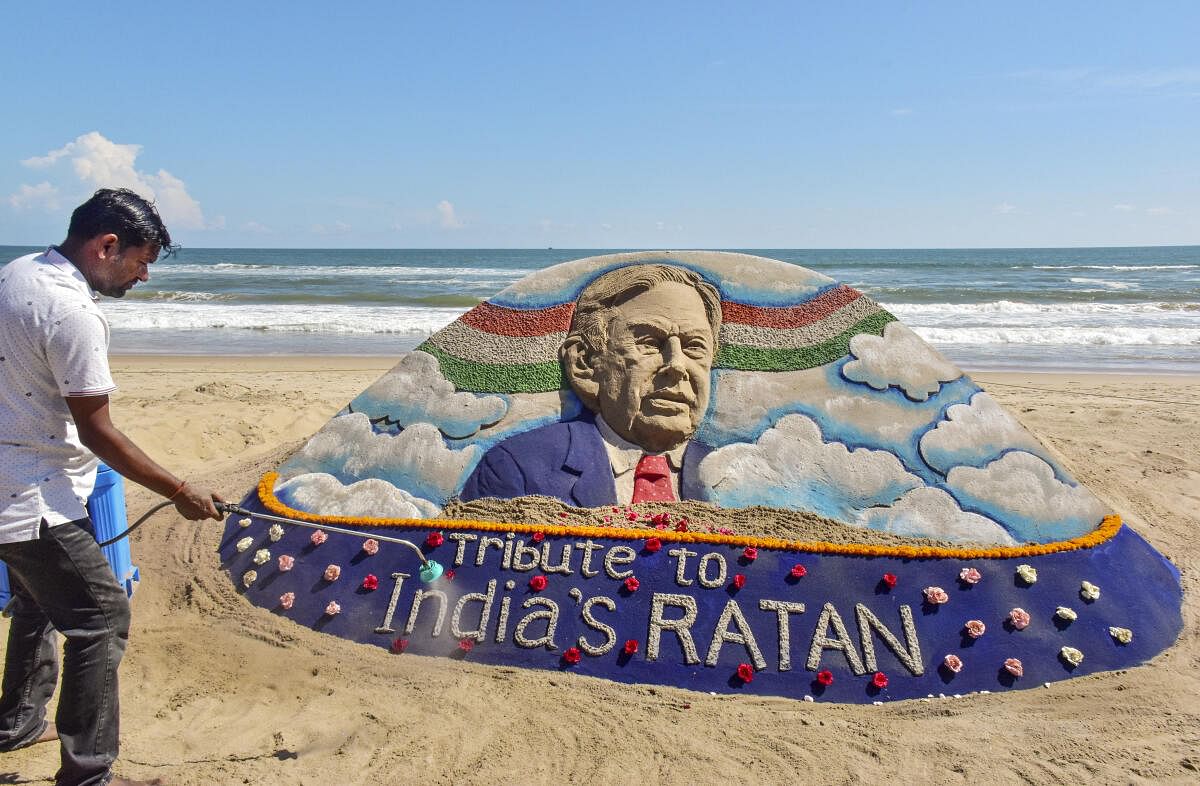 Sand artist Sudarsan Pattnaik creates a sand sculpture to pay tribute to Ratan Tata at Puri beach in Odisha.