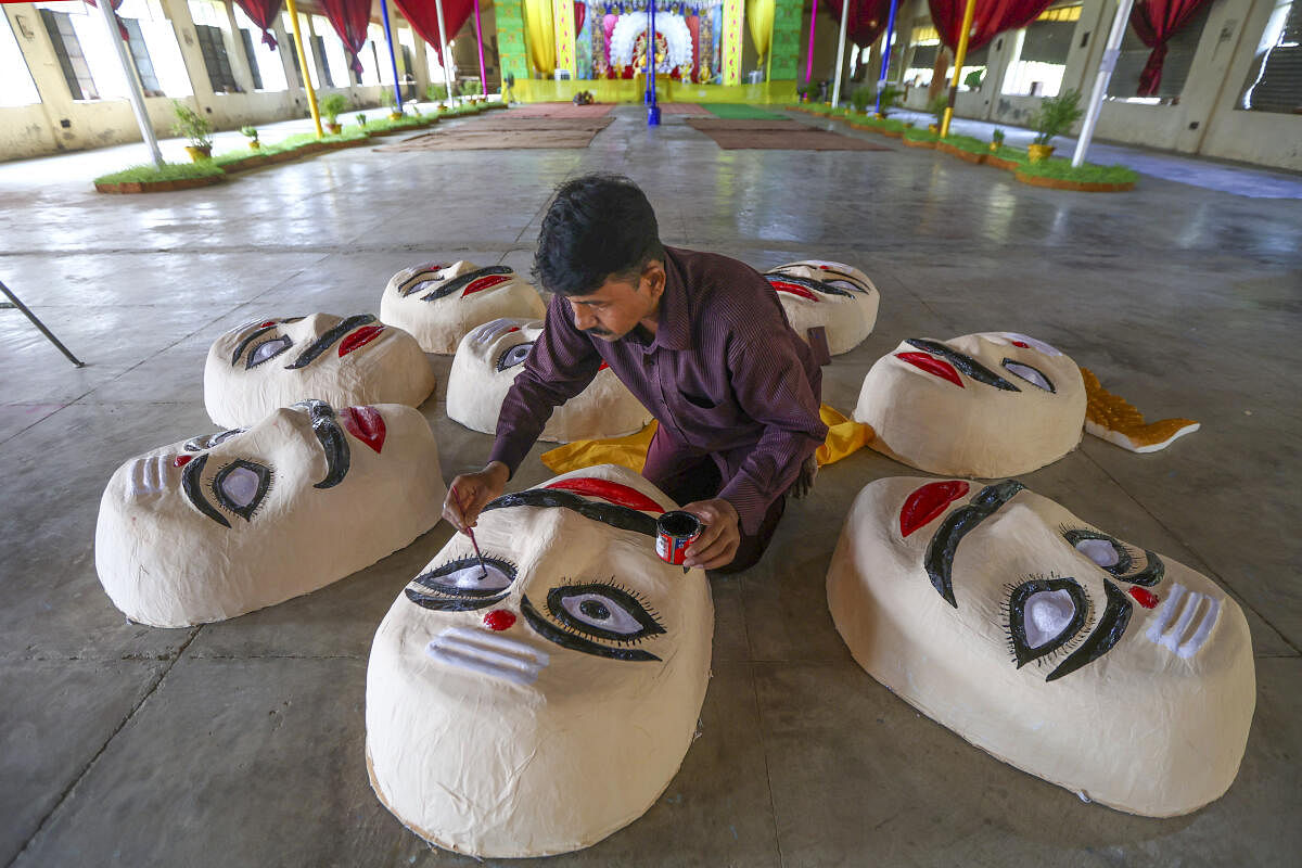 An artist prepares effigies of the demon king Ravana for the Dussehra festival celebration, in Prayagraj.