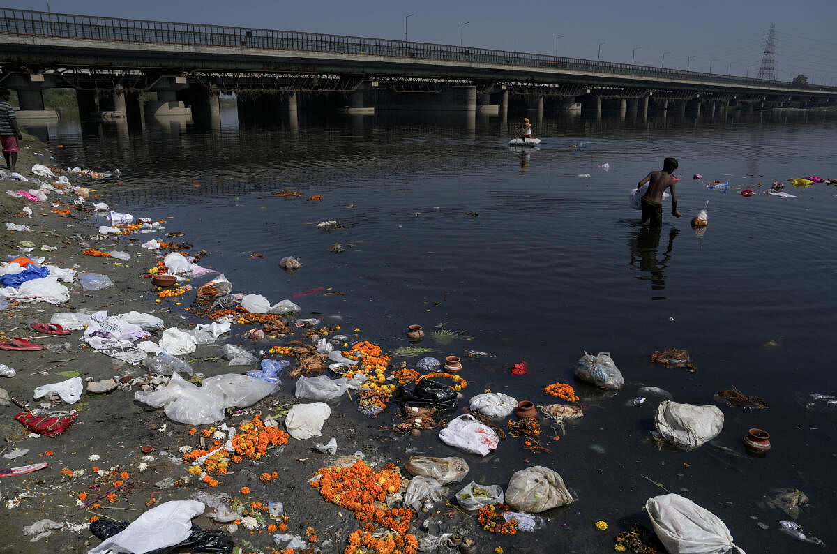 View of the Yamuna bank clogged with 'puja' offerings thrown by devotees at the end of Navratri festival, in New Delhi.