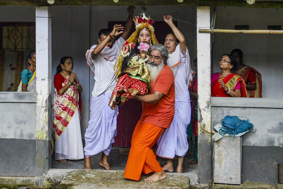 Priests carry a girl dressed as 'kumari' during 'Kumari Puja' as part of Navaratri festival, at the Ramakrishna Vivekananda Ashram on the outskirts of Agartala.