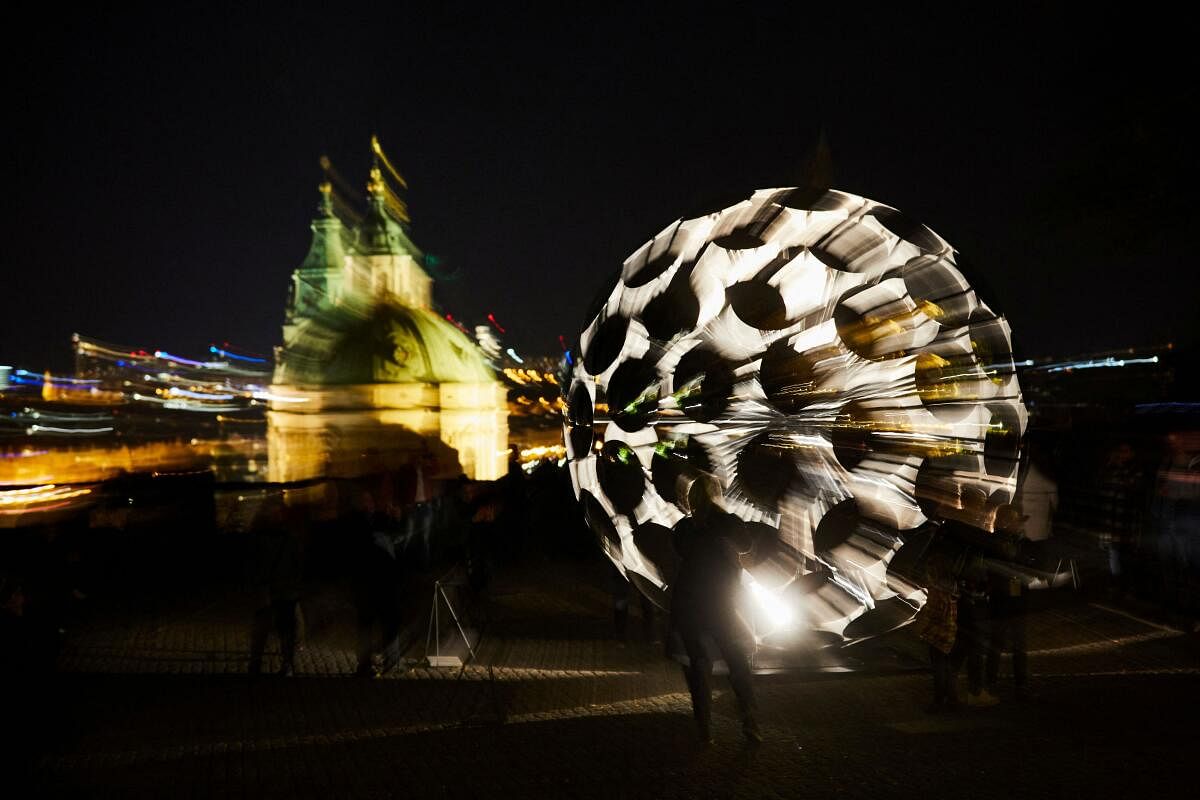 People stand in front of an installation during a light festival in Prague, Czech Republic.