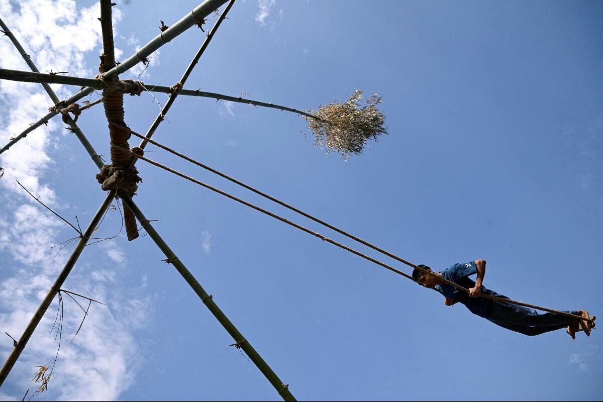 A man plays on a swing made from bamboo during Dashain, the country's biggest religious Hindu festival, in Kathmandu, Nepal.