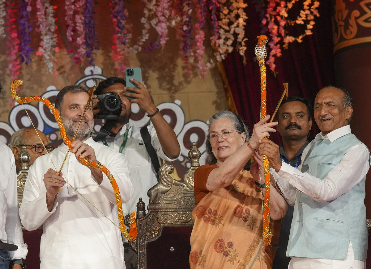 Congress leaders Sonia Gandhi and Rahul Gandhi hold bows and arrows during the ‘Dussehra’ (Vijayadashami) festival celebration organised by Nav Shri Dharmik Leela Committee, at the Red Fort ground, in New Delhi.