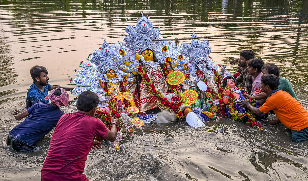 Devotees immerse an idol of Goddess Durga on the occasion of Vijayadashami, the last day of Durga Puja festival, in Nadia.