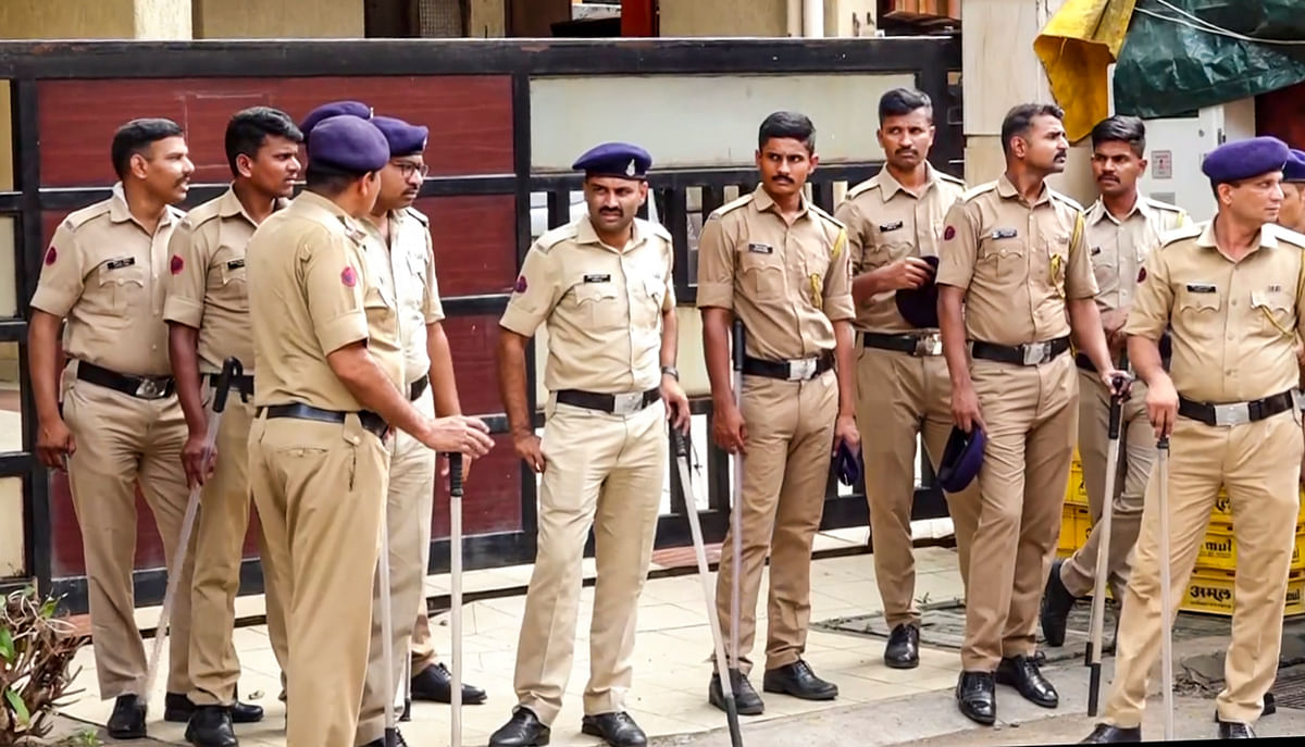 Security personnel stand guard outside deceased NCP leader Baba Siddique's residence, in Mumbai, Sunday, Oct. 13, 2024.