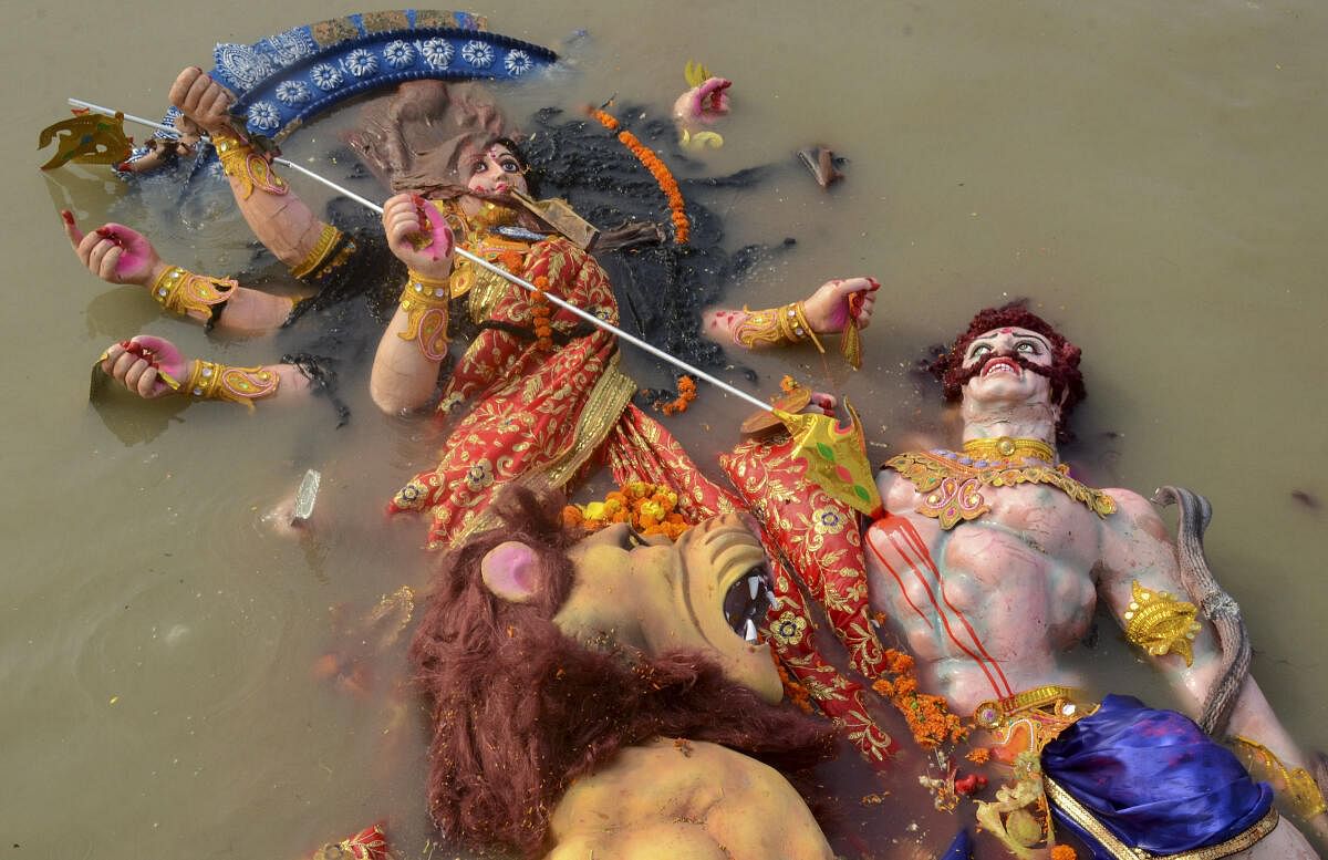 An idol of Goddess Durga being immersed in the Brahmaputra river at Lachit Ghat during ‘visarjan’ marking the end of the Durga Puja festival, in Guwahati.