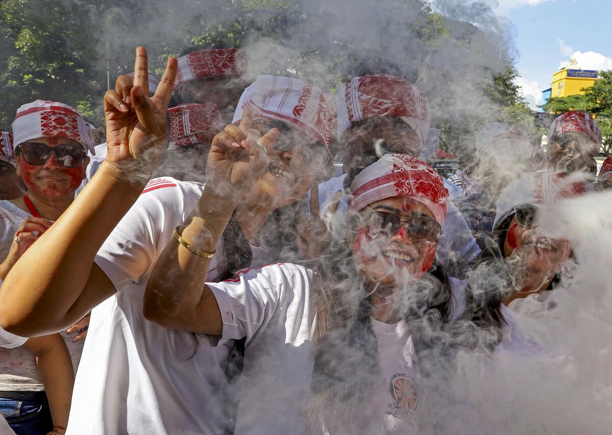 People from Bengali community perform a dance during a procession to immerse idols of goddess Durga on the last day of Vijayadashami festival, at Ulsoor Lake, in Bengaluru.