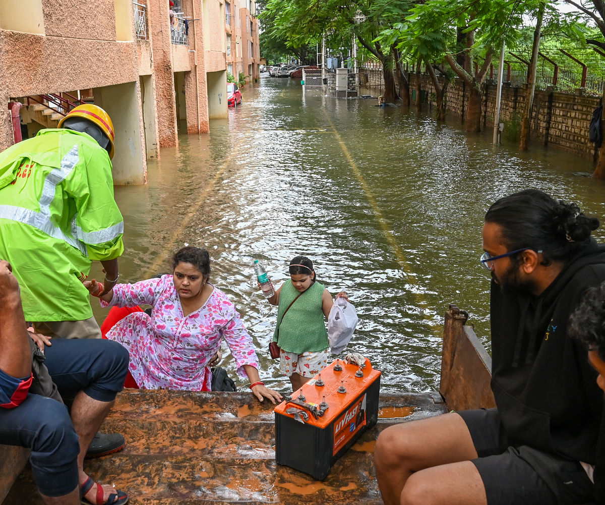 Tractors ferry residents in and out of Kendriya Vihar Apartment near Kogilu Cross in Yelahanka.