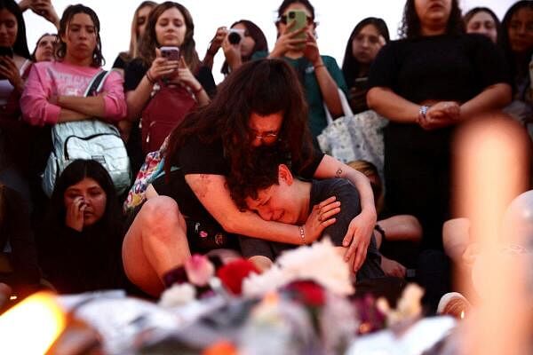 People react as they gather after Liam Payne, former One Direction band member, was found dead after he fell from a third-floor hotel room balcony, in Buenos Aires, Argentina.