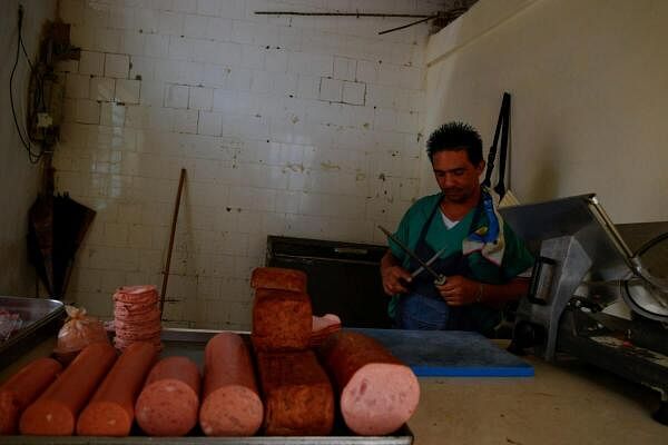 A butcher works behind a deli counter as Cuba is hit by an island-wide blackout, in Havana.