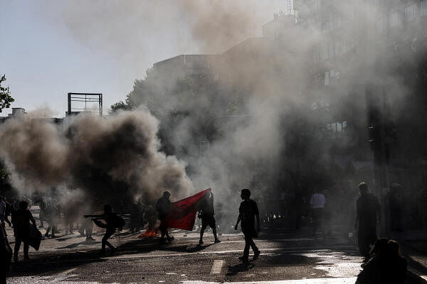 Demonstrators set on fire a barricade during a rally on the fifth anniversary of the protests and riots that rocked the country in 2019, in Santiago, Chile.