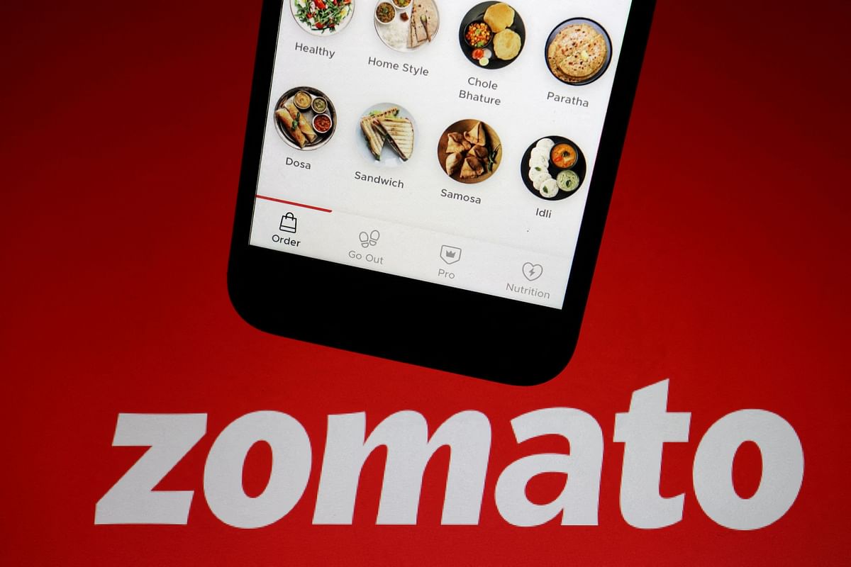 FILE PHOTO: The app of Indian food delivery company Zomato is seen on a mobile phone above its logo displayed in this illustration picture.