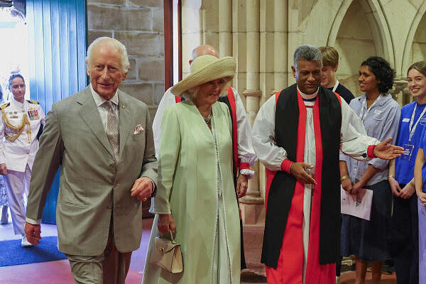 Britain's King Charles and Queen Camilla walk accompanied by Anglican Archbishop of Sydney, Reverend Kanishka Raffel, inside St. Thomas's Anglican Church, in Sydney.