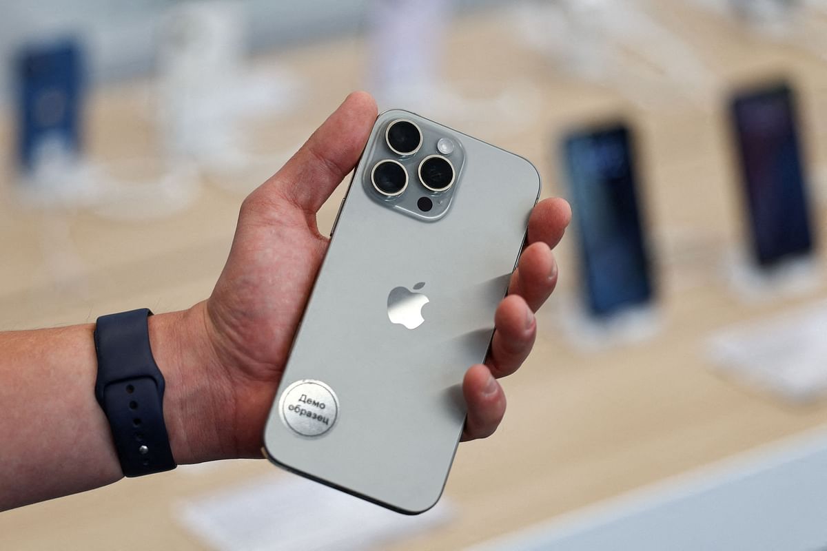 FILE PHOTO: A man holds an Apple iPhone 16 Pro Max ahead of the launch of sales of the new iPhone 16 series smartphones in a store.