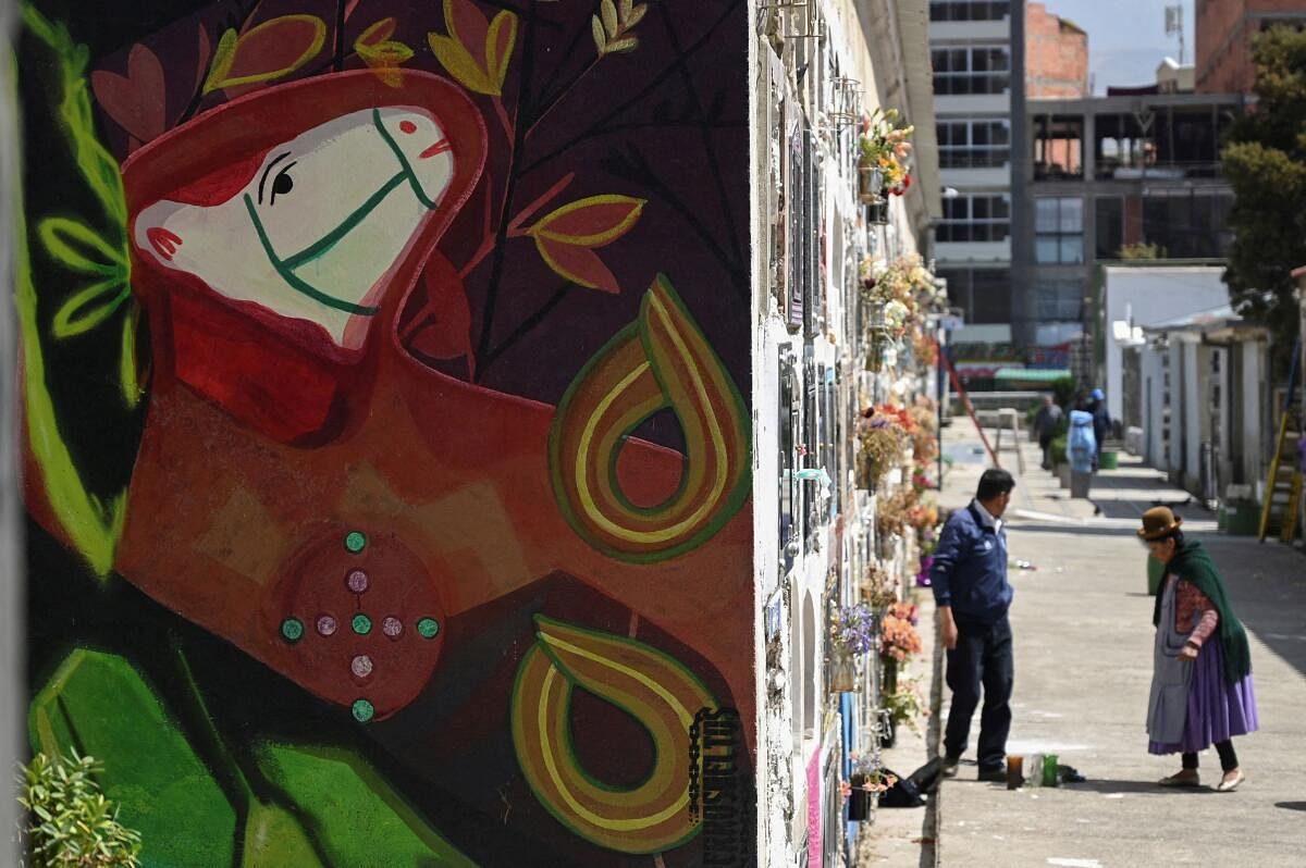 Artists paint murals as a prelude to the Day of the Dead at the General Cemetery, in La Paz