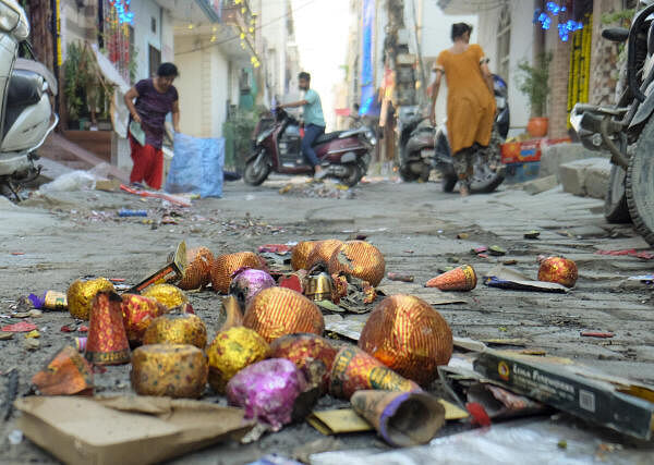 A road littered with waste from bursting of firecrackers, a day after Diwali festival celebrations, in Gurugram.