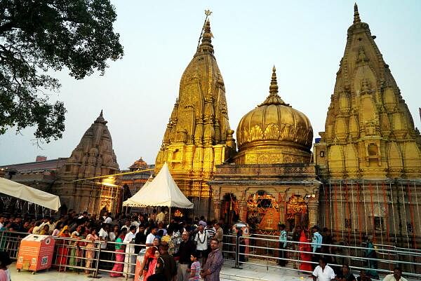 Devotees wait to offer prayers at the Kashi Vishwanath Temple on the occasion of Annakoot festival, in Varanasi.