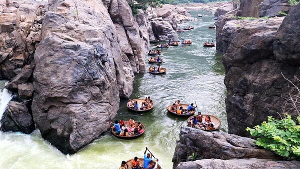 Tourists take a boat ride in the Kaveri river at the Hogenakkal waterfall during Diwali holidays, in Dharmapuri, Tamil Nadu.