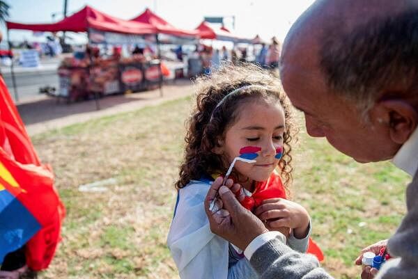 A girl has her face painted during a rally held by Frente Amplio presidential candidate Yamandu Orsi and his running mate Carolina Cosse in Montevideo, Uruguay.