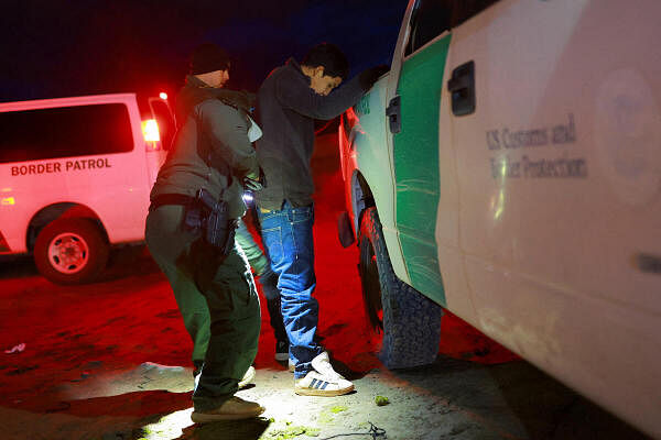 A migrant is detained by U.S. Border Patrol agents after crossing into the United States from Mexico, in Sunland Park, New Mexico, US November 4, 2024.